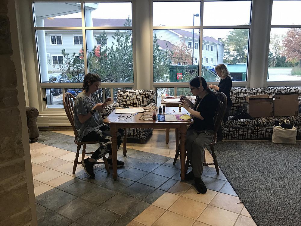 Students focus on painting tote bags at a fun sustainability event.